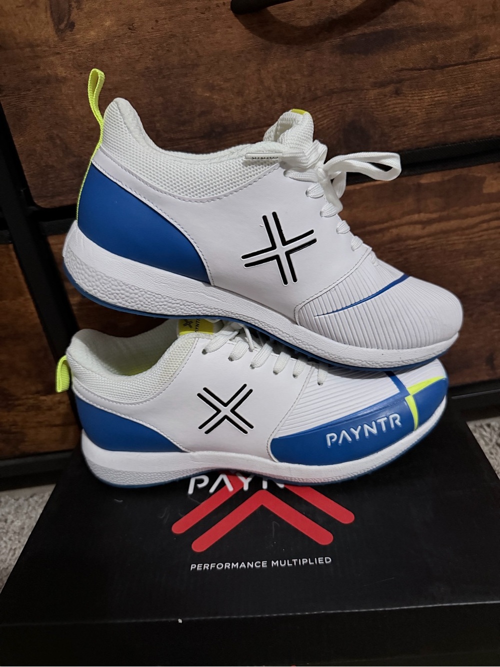 PAYNTR White & Blue Spike-Soled Athletic Shoe with Neon Yellow Trim